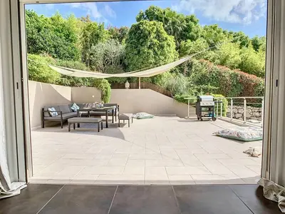 an open door to a patio with a table and chairs at Villa Bamboo in Cannes