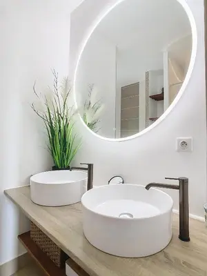 a bathroom with two sinks and a mirror at Villa Bamboo in Cannes
