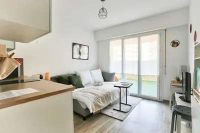 a living room with a couch and a table at Studio with a 20sqm terrace 10min from la Croisette in Cannes
