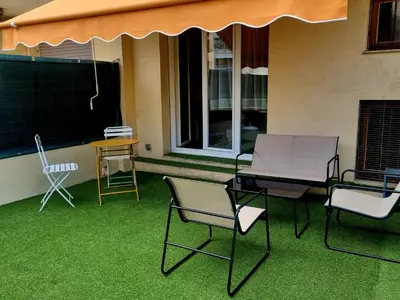 a group of chairs sitting on a patio with grass at Studio with a 20sqm terrace 10min from la Croisette in Cannes