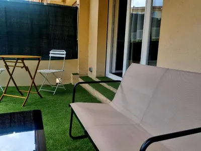 a balcony with a chair and a table and a table at Studio with a 20sqm terrace 10min from la Croisette in Cannes