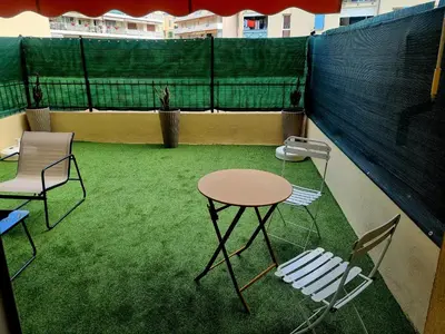 a table and two chairs and a table on a tennis court at Studio with a 20sqm terrace 10min from la Croisette in Cannes
