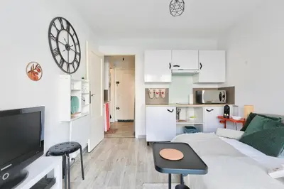 a living room with a couch and a tv at Studio with a 20sqm terrace 10min from la Croisette in Cannes