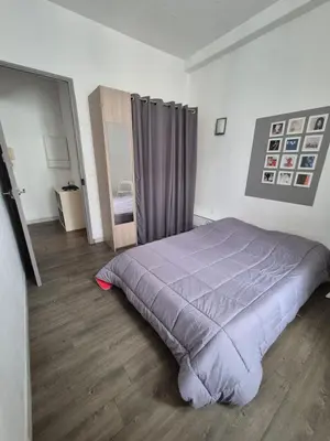 a bedroom with a bed with a purple comforter at Cannes centre - Vieux port in Cannes