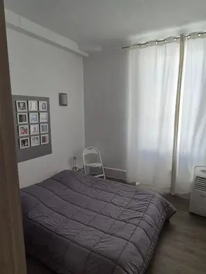 a bedroom with a bed with a purple blanket at Cannes centre - Vieux port in Cannes