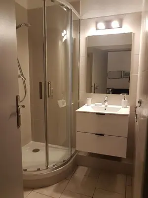 a bathroom with a shower and a sink and a mirror at Cannes centre - Vieux port in Cannes