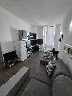 a living room with a couch and a kitchen at Cannes centre - Vieux port in Cannes