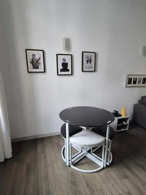 a table and two chairs in a living room at Cannes centre - Vieux port in Cannes