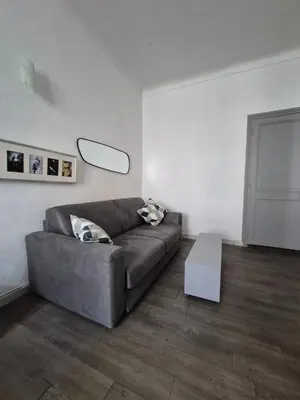a living room with a couch and a table at Cannes centre - Vieux port in Cannes