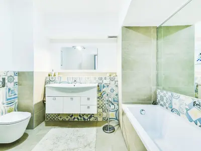 a bathroom with a tub and a toilet and a sink at Apartment Le Katia-2 by Interhome in Cannes