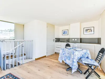 a kitchen and dining room with a table and chairs at Apartment Le Katia-2 by Interhome in Cannes