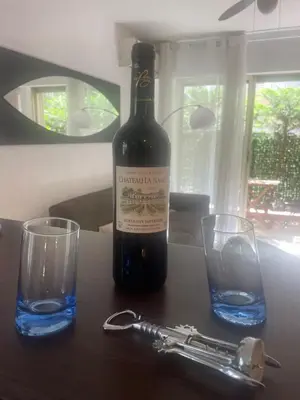 a bottle of wine and two glasses on a table at Apartment Cannes Croisette near seaside in Cannes