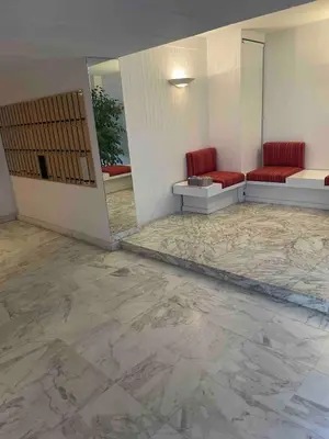 a room with two red chairs and a marble floor at Apartment Cannes Croisette near seaside in Cannes
