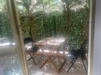 a table and two chairs on a screened in porch at Apartment Cannes Croisette near seaside in Cannes