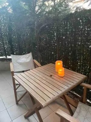 two orange cups sitting on a wooden table on a patio at Apartment Cannes Croisette near seaside in Cannes