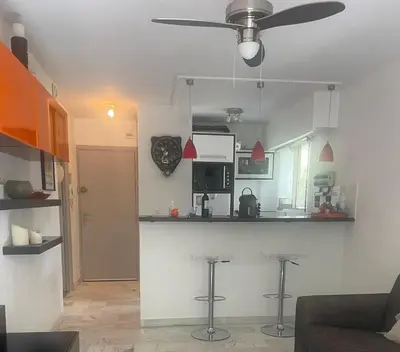 a kitchen with a bar and stools in a room at Apartment Cannes Croisette near seaside in Cannes