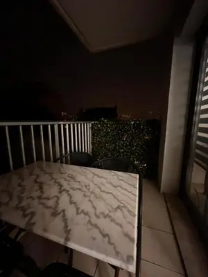 a white table on a balcony at night at Large Studio in Cannes near la Croisette and beach in Cannes
