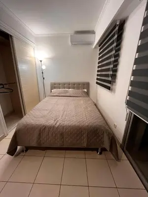 a bedroom with a bed in a white room at Large Studio in Cannes near la Croisette and beach in Cannes