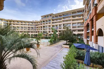 an apartment building with a courtyard with plants at LX122 Terrasse, piscine & plage à pied - Cannes in Cannes