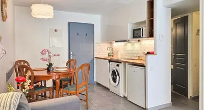 a kitchen and dining room with a table and a dining room at LX122 Terrasse, piscine & plage à pied - Cannes in Cannes