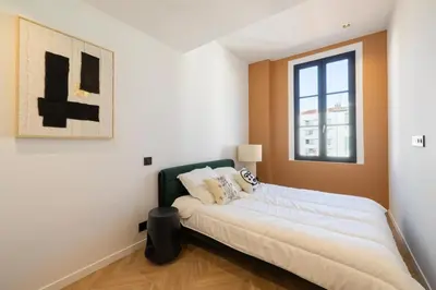 a bedroom with a bed and a window at REF 1993 - Cannes Center Renovated Apartment in Cannes