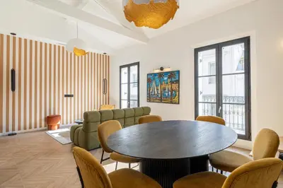 a waiting room with a table and chairs at REF 1993 - Cannes Center Renovated Apartment in Cannes
