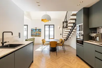 a kitchen and dining room with a table and chairs at REF 1993 - Cannes Center Renovated Apartment in Cannes