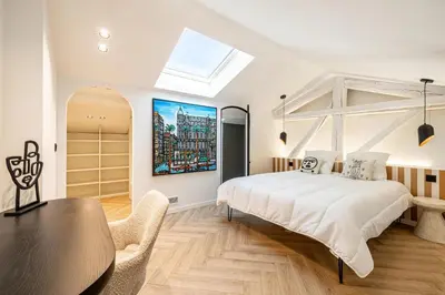 a bedroom with a large bed and a table and chairs at REF 1993 - Cannes Center Renovated Apartment in Cannes