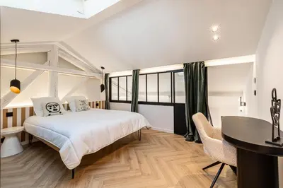 a bedroom with a bed and a desk and a table at REF 1993 - Cannes Center Renovated Apartment in Cannes