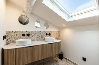 two sinks in a bathroom with a skylight at REF 1993 - Cannes Center Renovated Apartment in Cannes