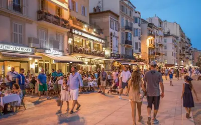 a crowd of people walking down a city street at Aparthotel Seaside Cannes Festival Suite in Cannes
