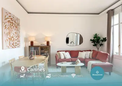 a living room with a red couch and a table at Cannes centre - 10mn Palais, Croisette, Plage - CY in Cannes