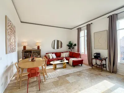 a living room with a red couch and a table at Cannes centre - 10mn Palais, Croisette, Plage - CY in Cannes