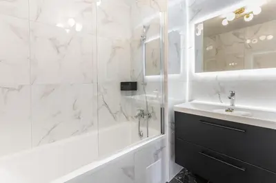 a white bathroom with a tub and a sink at Luxurious Apartment with Sea and Carlton View in Cannes