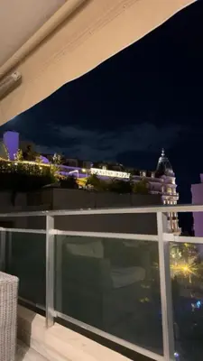 a balcony with a view of a city at night at Luxurious Apartment with Sea and Carlton View in Cannes