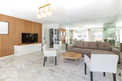 a living room with a couch and a tv at Luxurious Apartment with Sea and Carlton View in Cannes