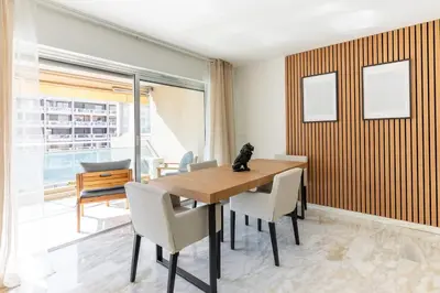 a dining room with a wooden table and chairs at Luxurious Apartment with Sea and Carlton View in Cannes