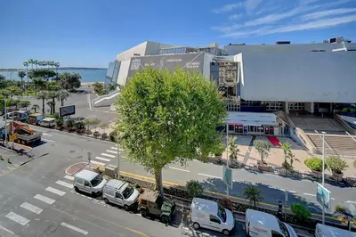 a city street with cars parked in front of a building at REF 1392 - Cannes palais des festivals apartment for rent in Cannes