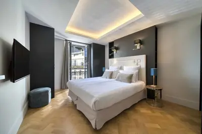 a bedroom with a large white bed and a window at REF 1392 - Cannes palais des festivals apartment for rent in Cannes