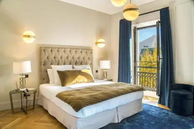 a bedroom with a bed and a large window at REF 1392 - Cannes palais des festivals apartment for rent in Cannes