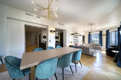 a dining room with a table and blue chairs at REF 1392 - Cannes palais des festivals apartment for rent in Cannes