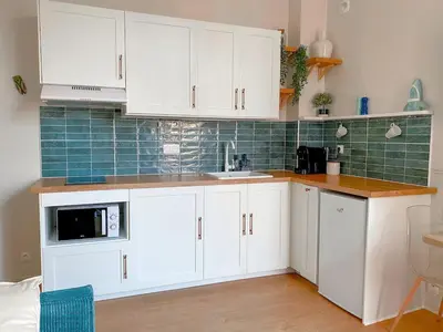 a kitchen with white cabinets and a microwave at Charmant 2P avec Balcon, Proche Centre in Cannes