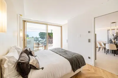 a bedroom with a large bed and a balcony at REF 1981 - Cannes sea view apartment Cannes Palm Beach in Cannes