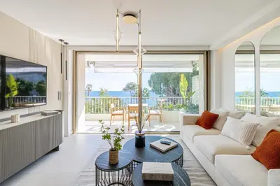 a living room with a couch and a table at REF 1981 - Cannes sea view apartment Cannes Palm Beach in Cannes