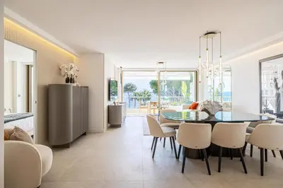 a kitchen and dining room with a table and chairs at REF 1981 - Cannes sea view apartment Cannes Palm Beach in Cannes