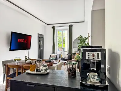 a living room with a coffee machine on a counter at Grand appartement rénové - Jardin et Parking - CZ in Cannes