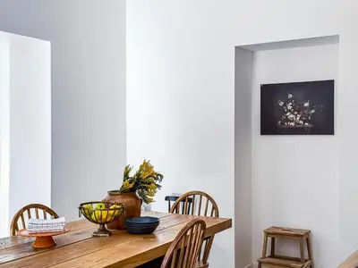a dining room with a wooden table and chairs at Bel appartement rénové - Jardin et Parking - DA in Cannes