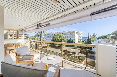 a balcony with chairs and tables on a building at REF 1980 - Cannes palm Beach sea view in Cannes