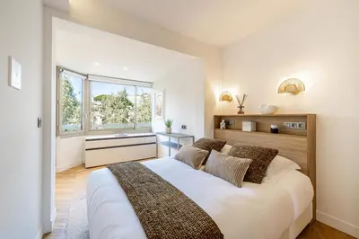 a bedroom with a large bed and a window at REF 1980 - Cannes palm Beach sea view in Cannes