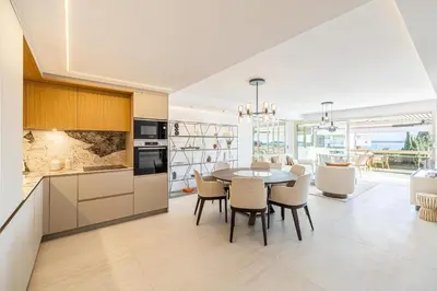 a kitchen and dining room with a table and chairs at REF 1980 - Cannes palm Beach sea view in Cannes